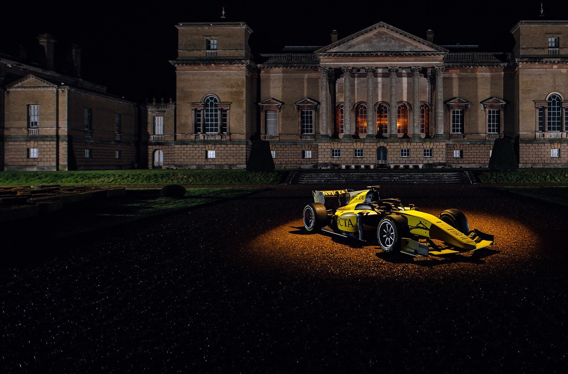 Invicta Racing racing car in spotlights