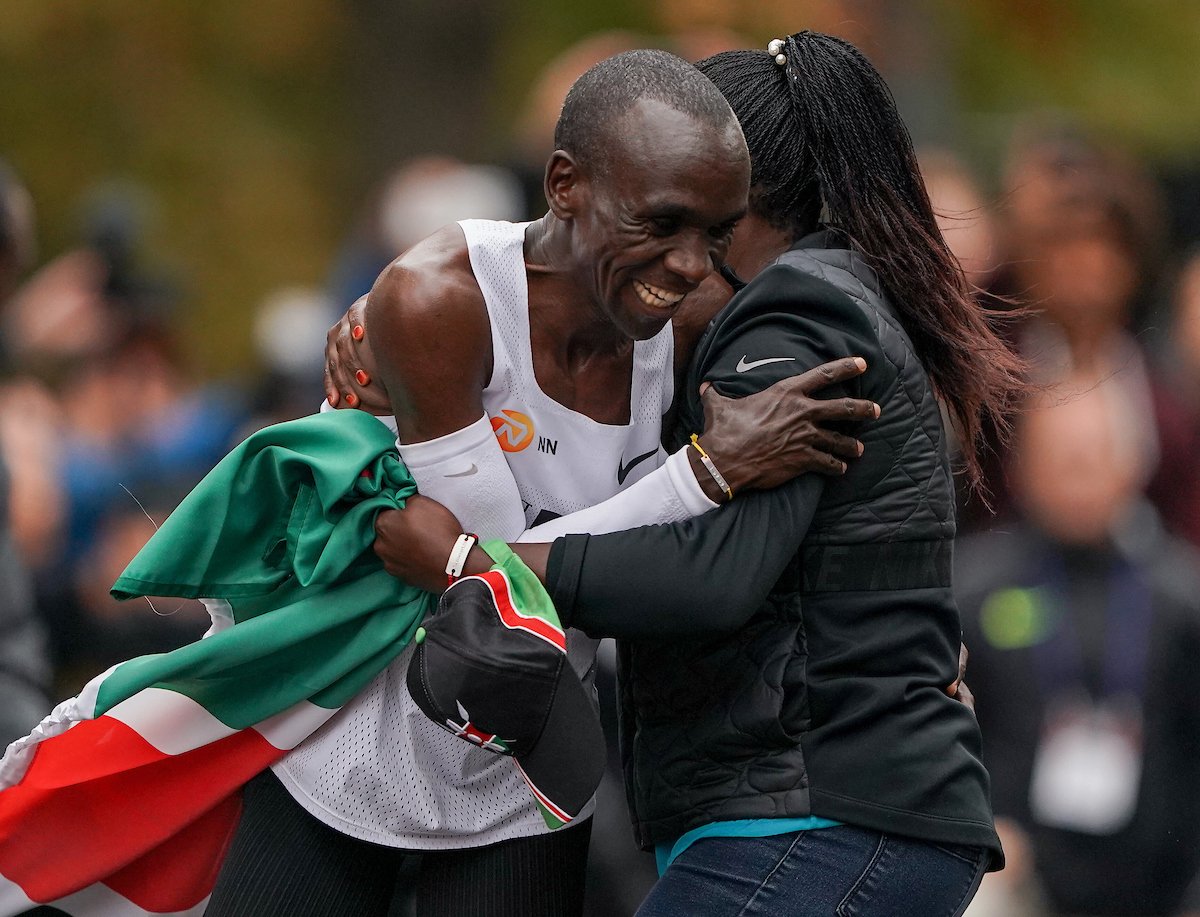 Happy Eliud Kipchoge gives a hug after breaking a world record