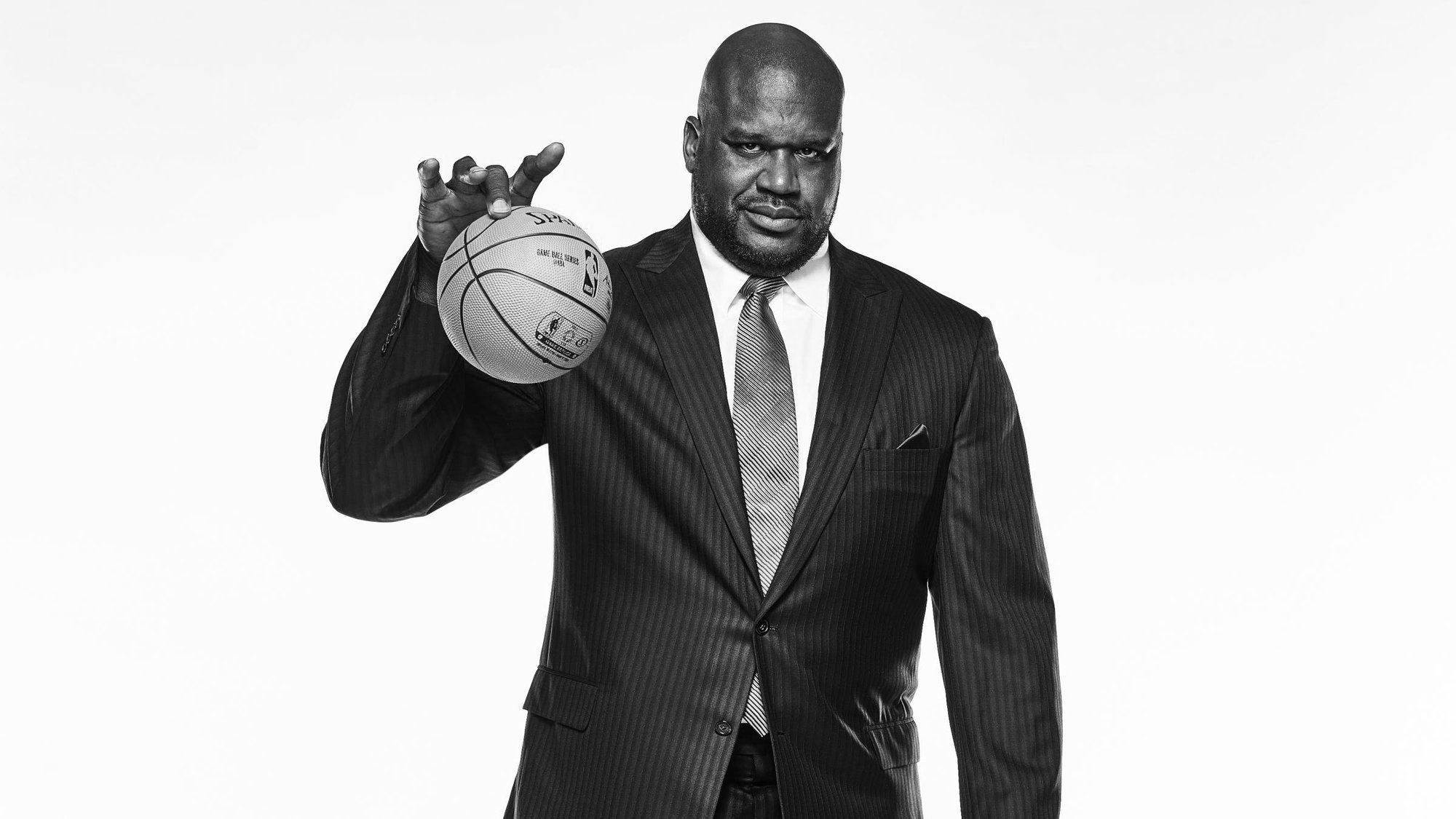 Shaquille O'Neal playing with a small basketball