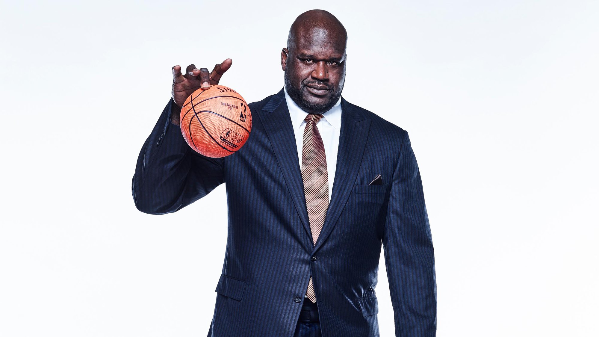 Shaquille O'Neal plays with a small basketball