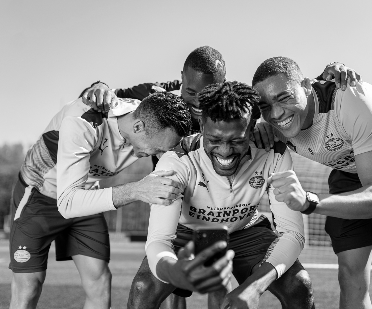 Laughing PSV players during a photoshoot for Anycoin Direct