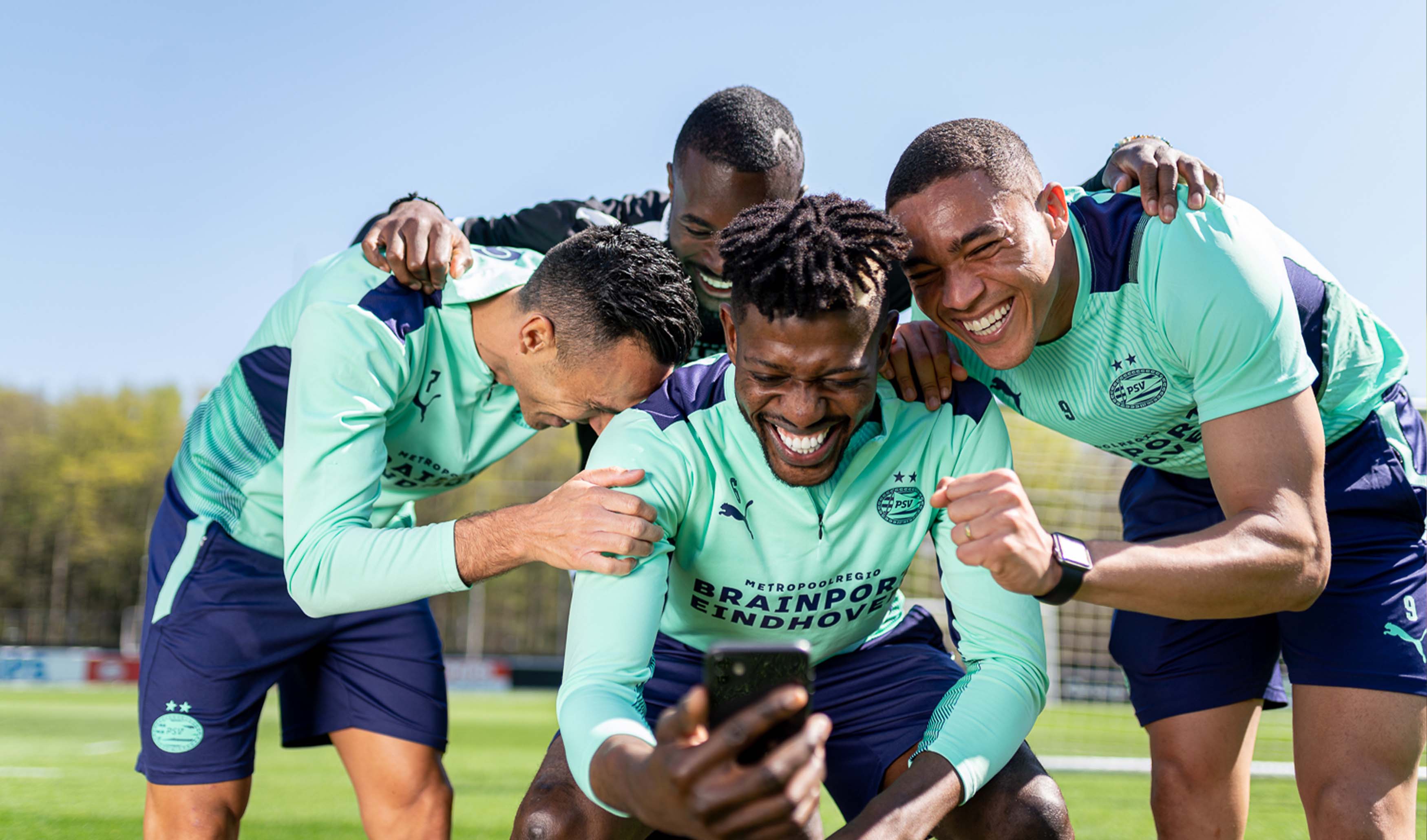 Laughing players of PSV at a photoshoot for Anycoin Direct