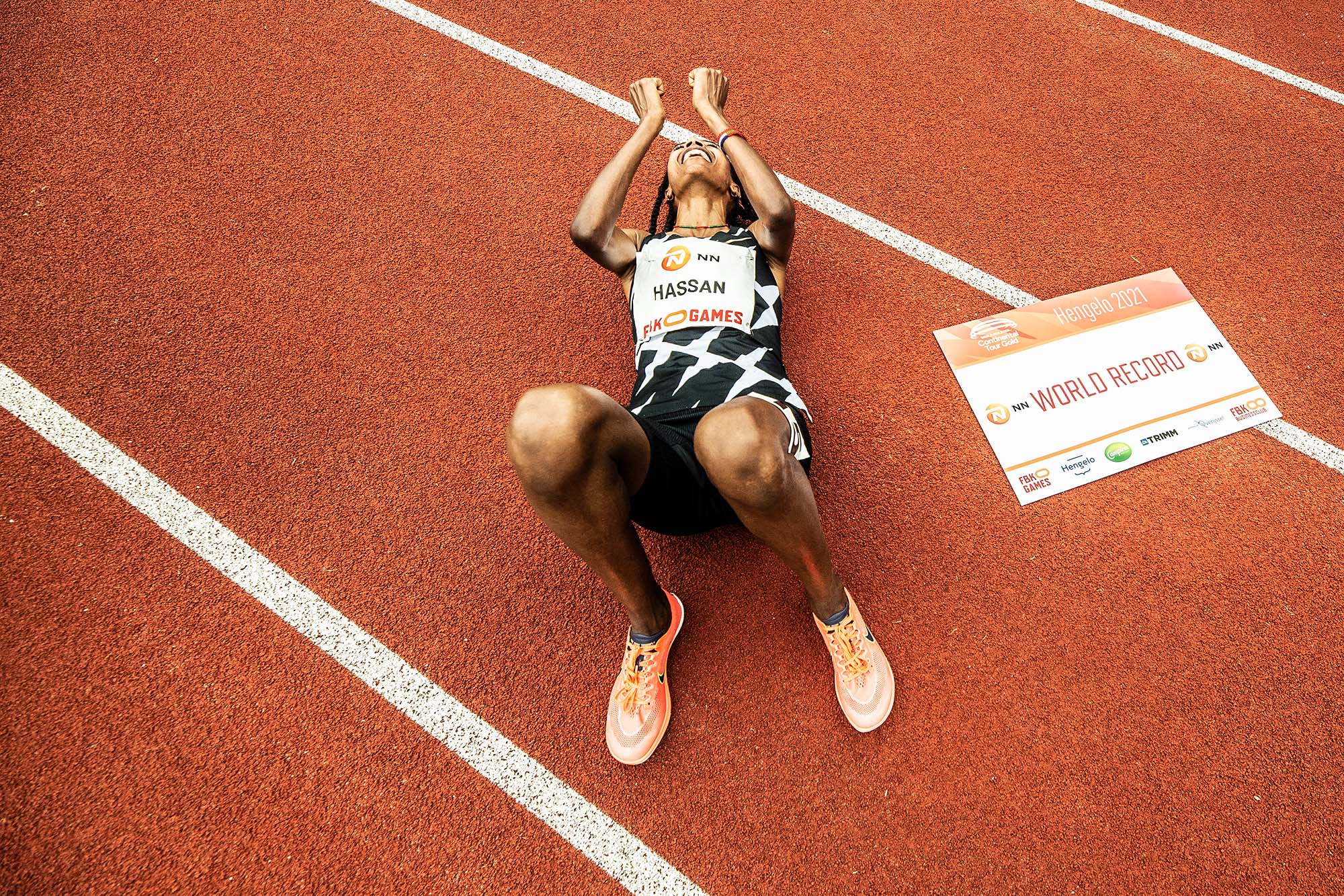 Sifan Hassan lies on the ground after winning at the FBK Games
