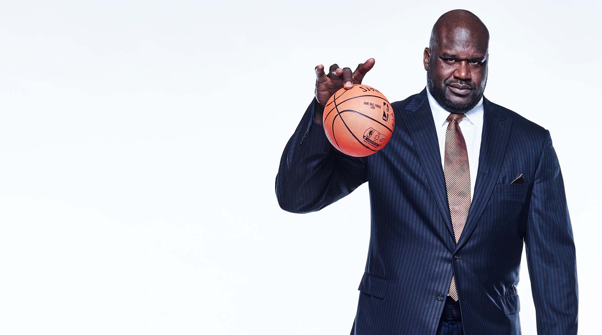 Shaquille O'Neal plays with a small basketball